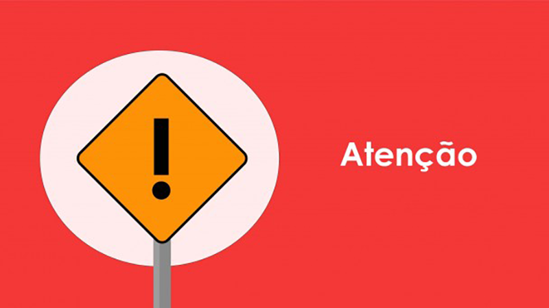 Placa com sinalização de bloqueio de estrada e palavra atenção.